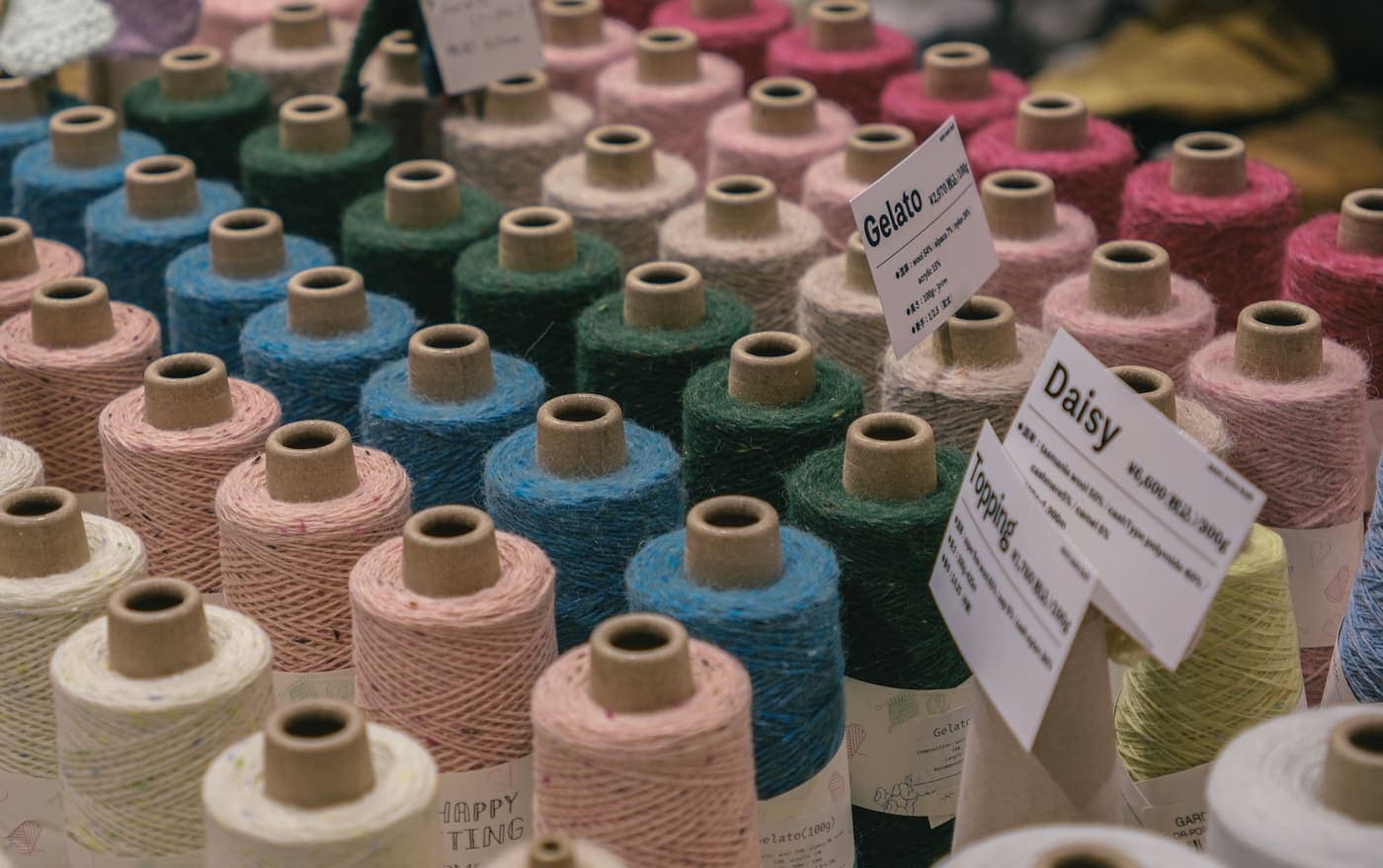 Colorful yarn spools on display at a craft market