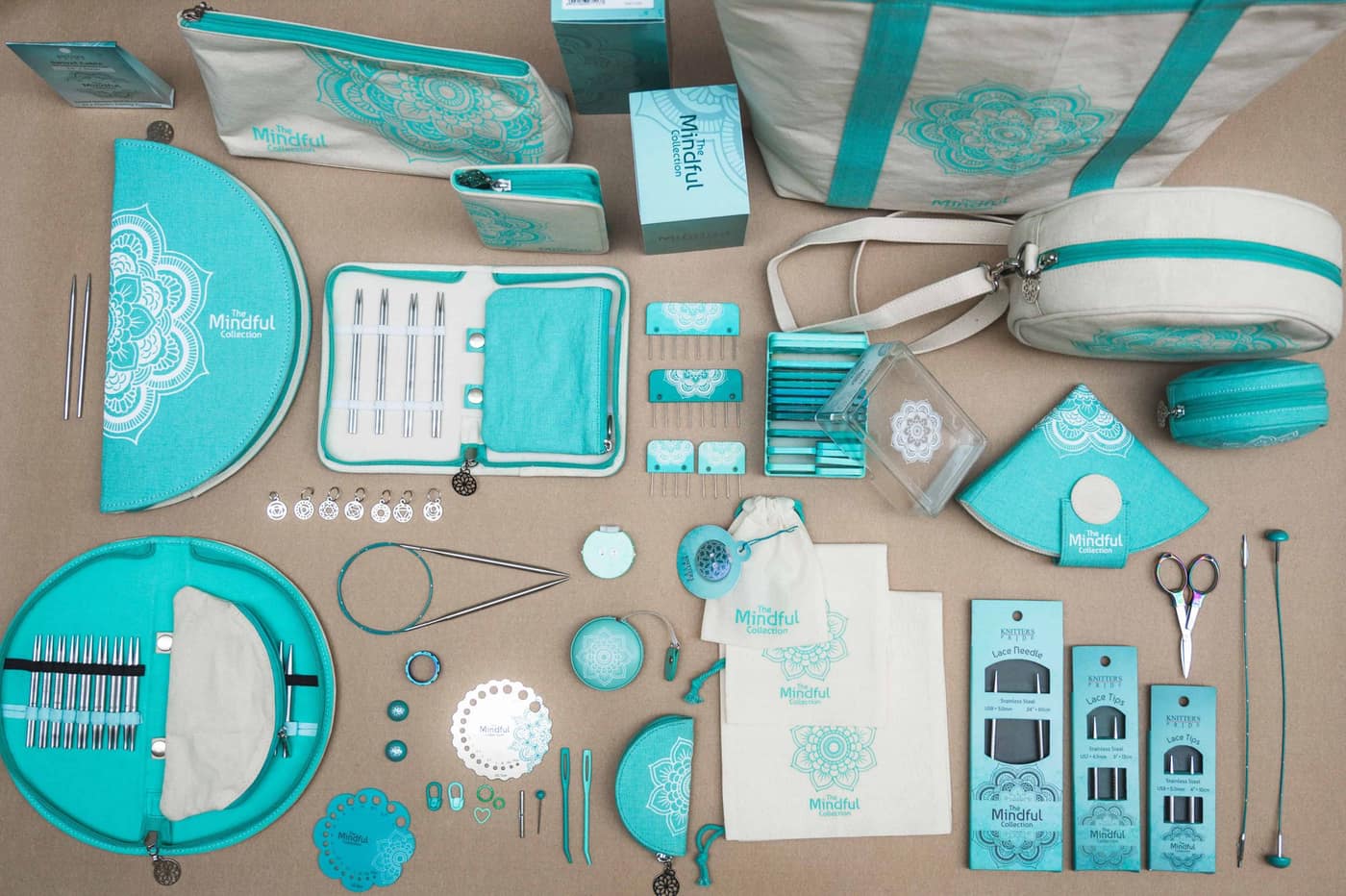 A flat lay of a sewing kit with turquoise accessories and small tools