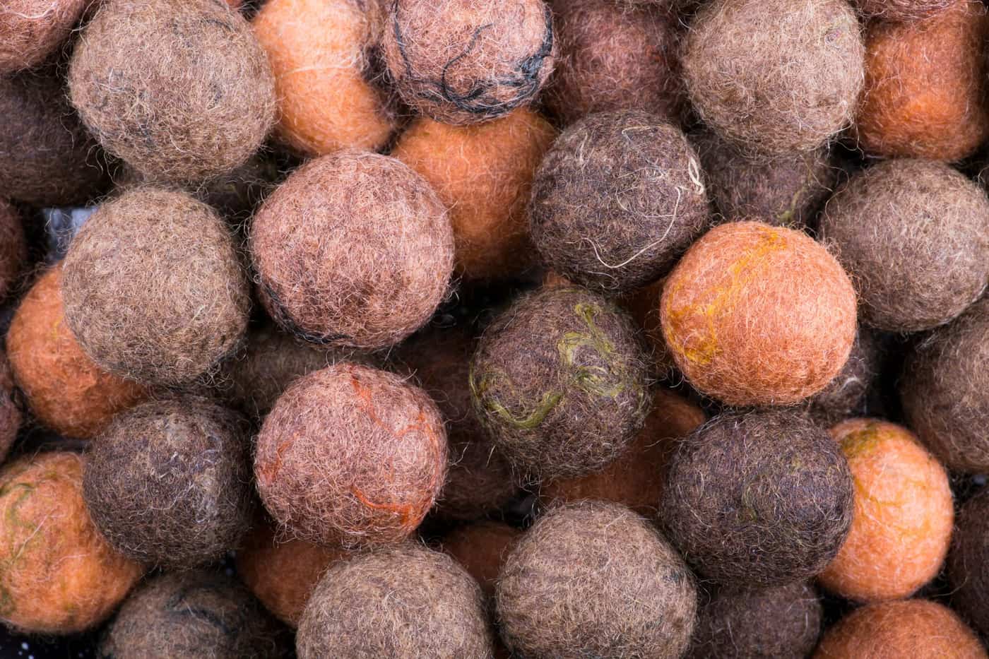 A close view of colorful felted wool balls forming a dense textured pattern