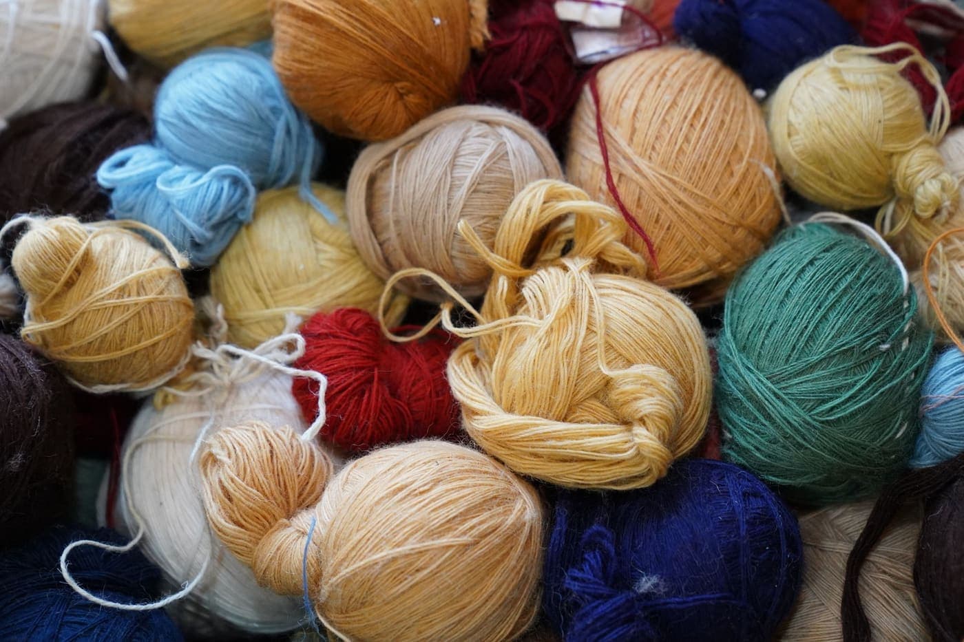 An assortment of colorful yarn balls arranged together