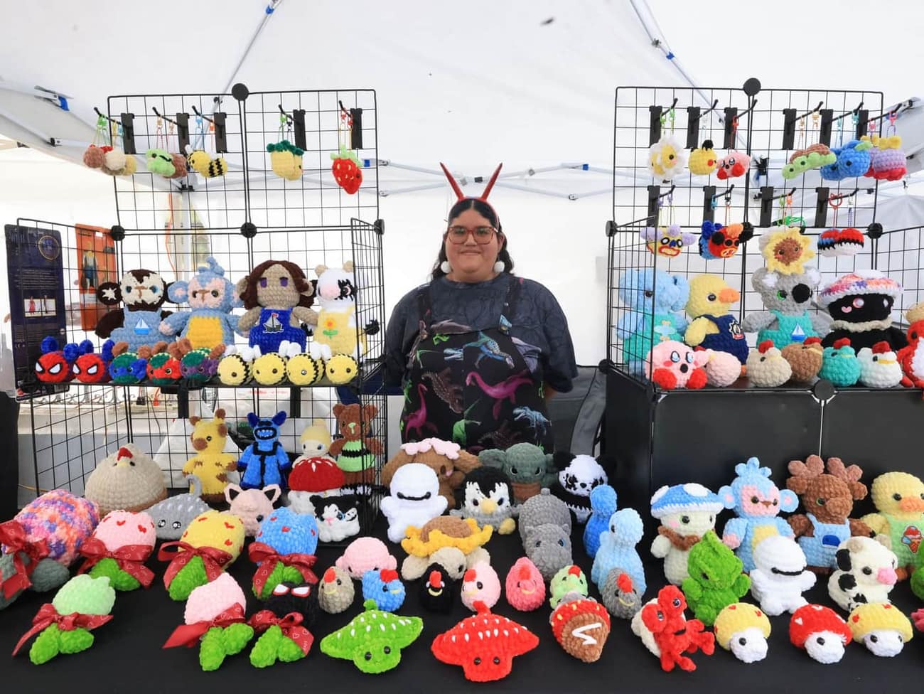 Colorful crochet toys on display at an outdoor craft market
