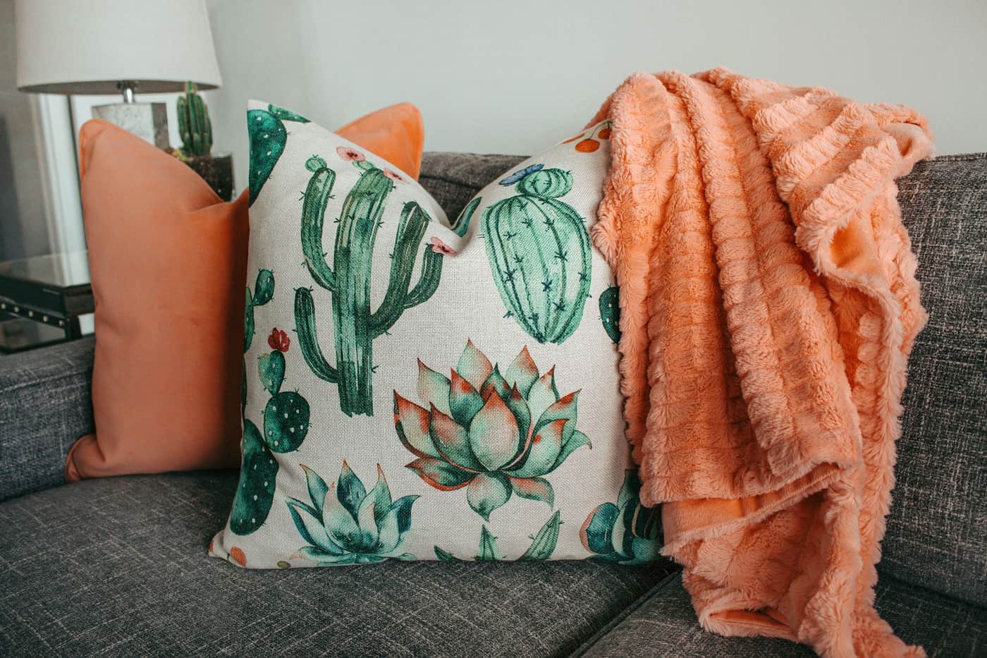 A cozy blanket and cushions on a modern couch