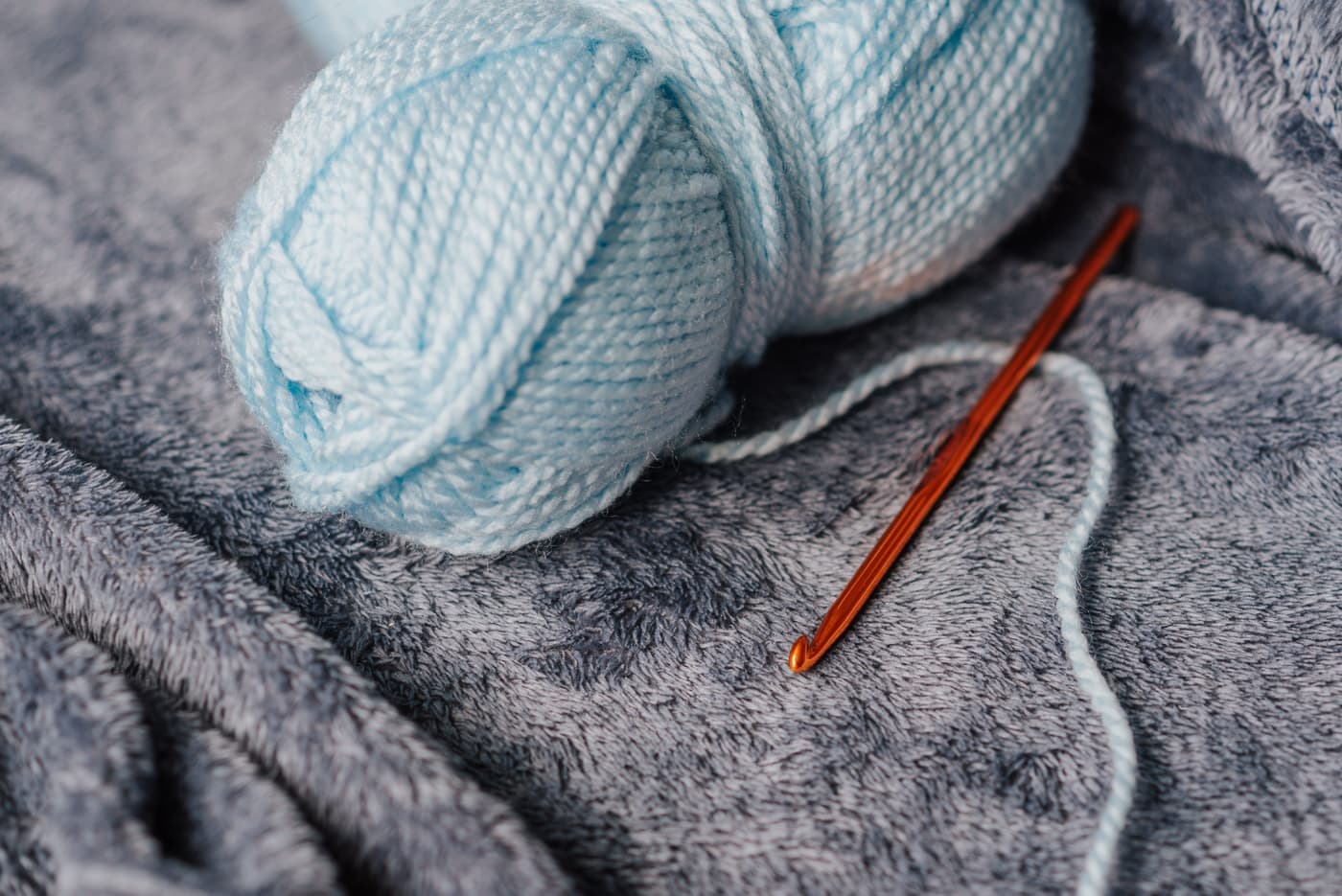 A large hook working into thick chenille blanket yarn