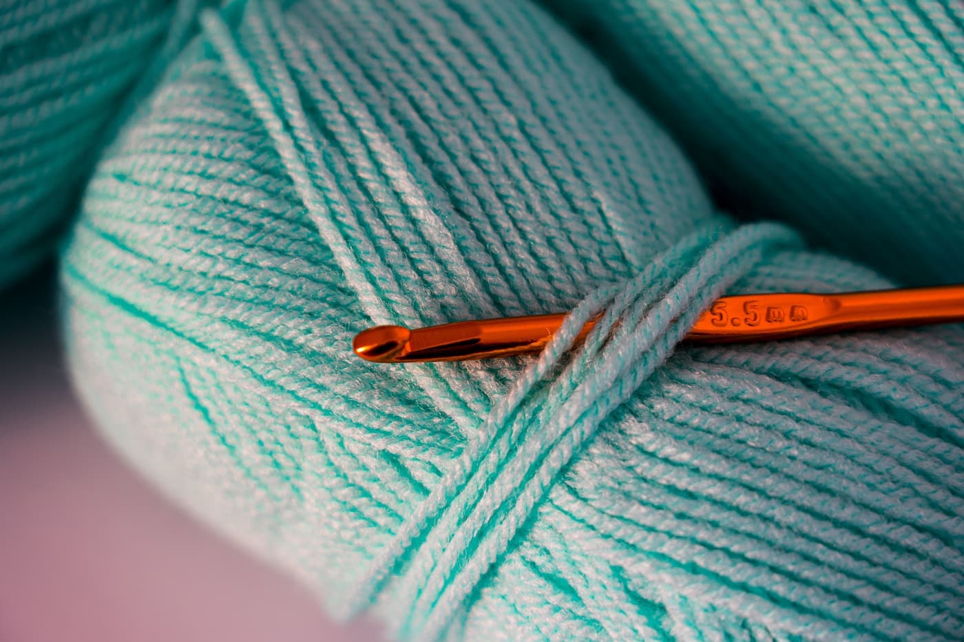 A crochet hook working into smooth mercerized cotton yarn