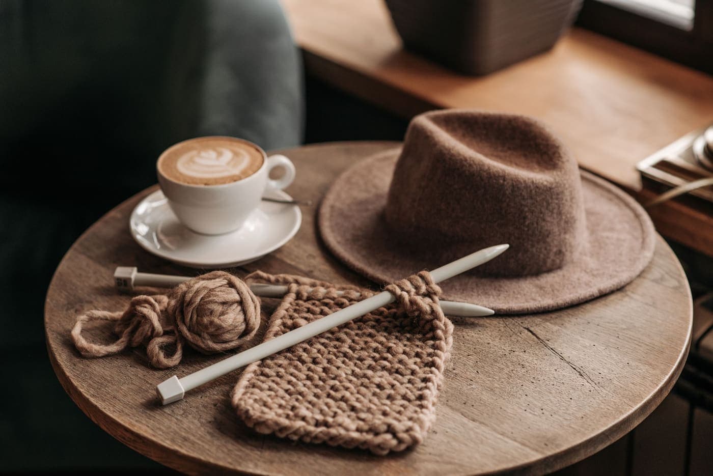 Coffee, knitting and a hat on a rustic table