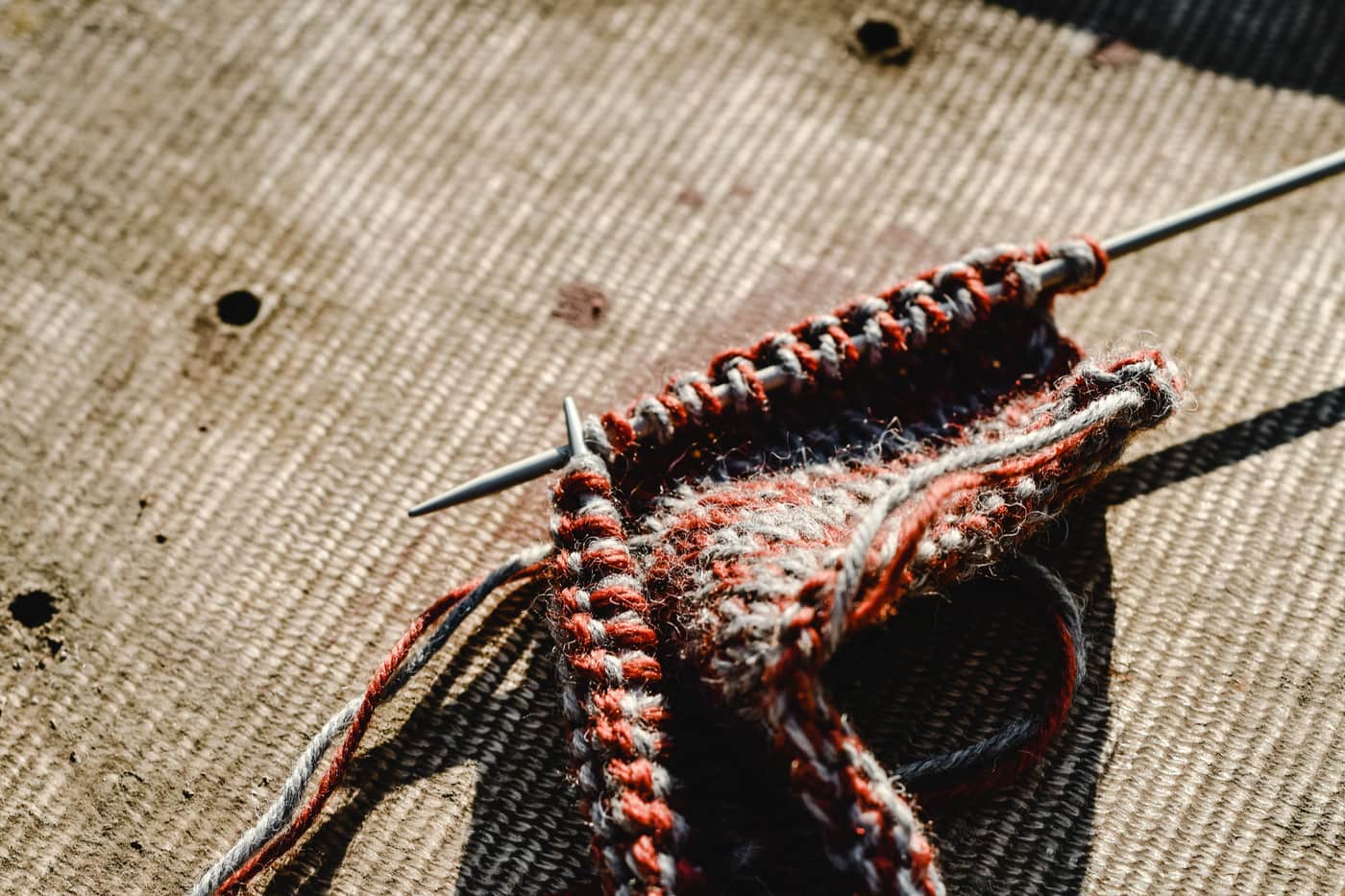 A circular needle with the cable pulled into a loop while knitting in the round