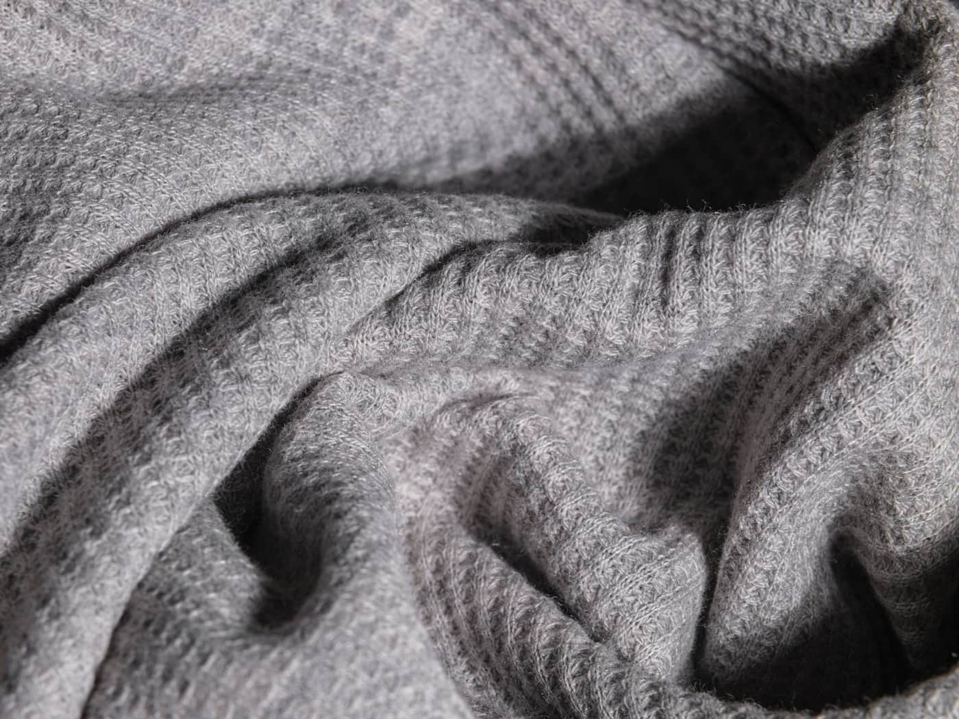 Close-up of soft gray knitted fabric showing its texture