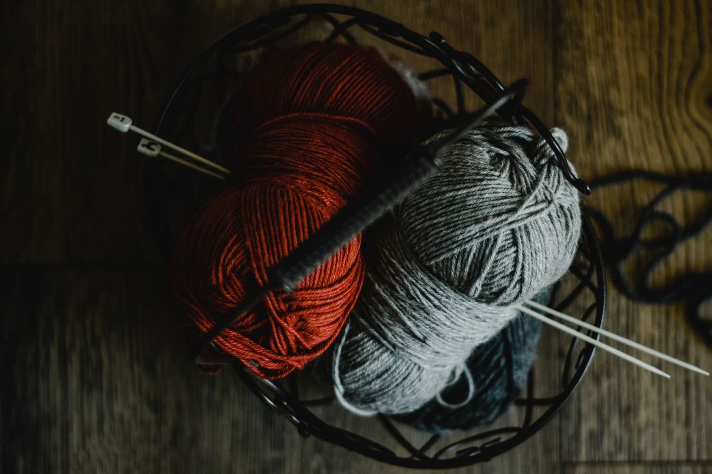 Knitting needles and balls of yarn arranged together