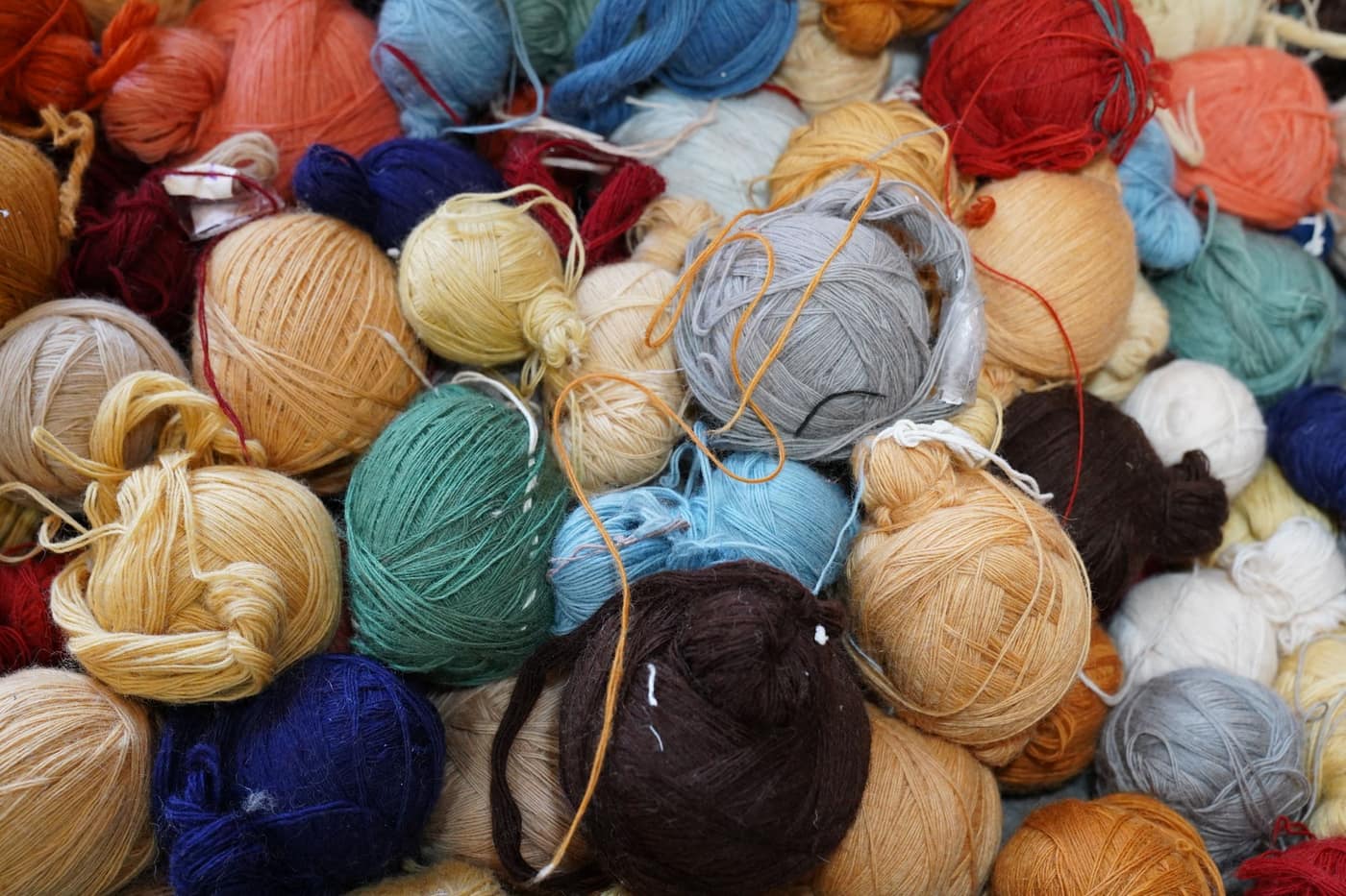 An assortment of yarn balls in many colors and fiber types