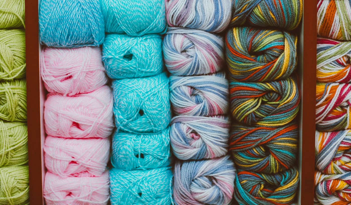 Yarn balls in many colors arranged in a neat pattern