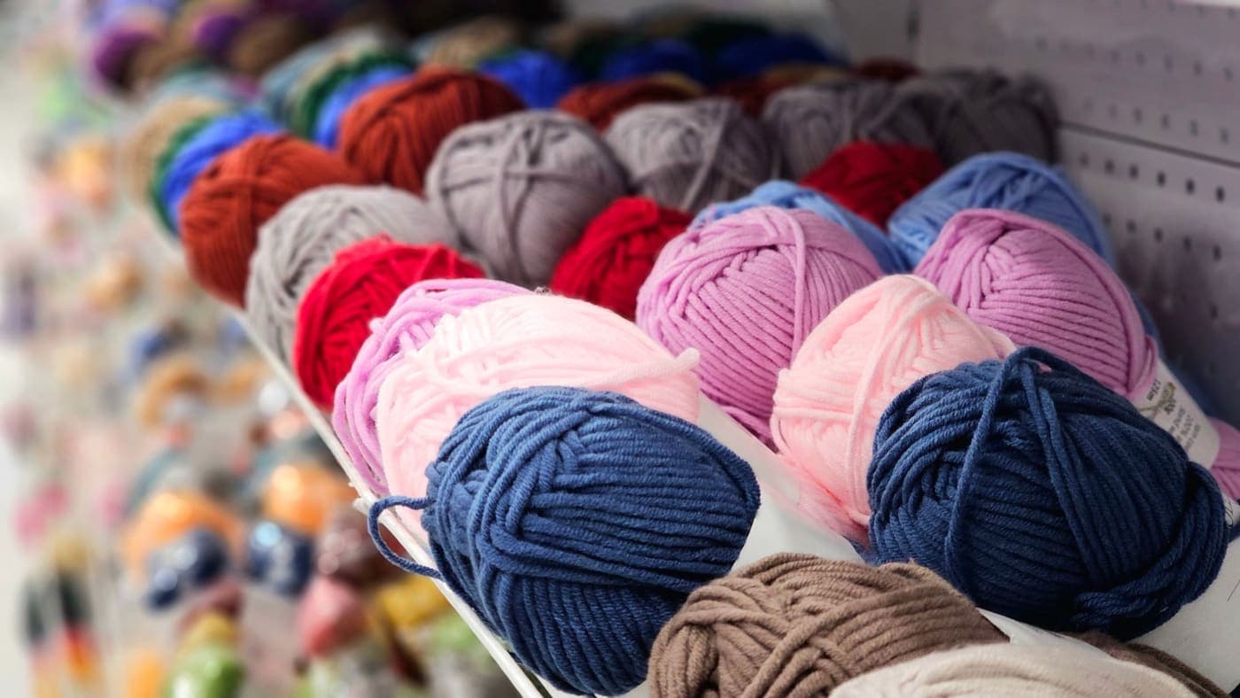 Colorful yarn balls displayed on a shelf