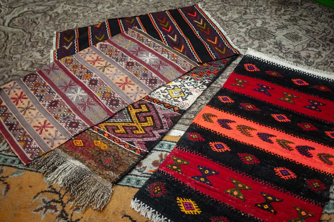 Handwoven rugs with geometric patterns displayed together