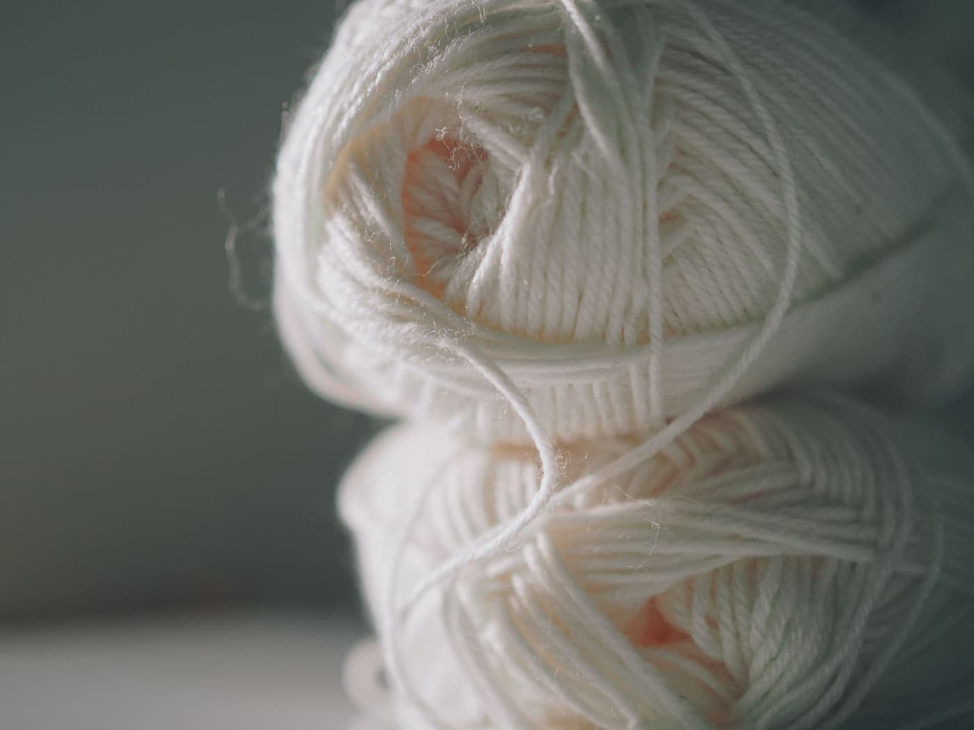 Soft white balls of yarn stacked closely together
